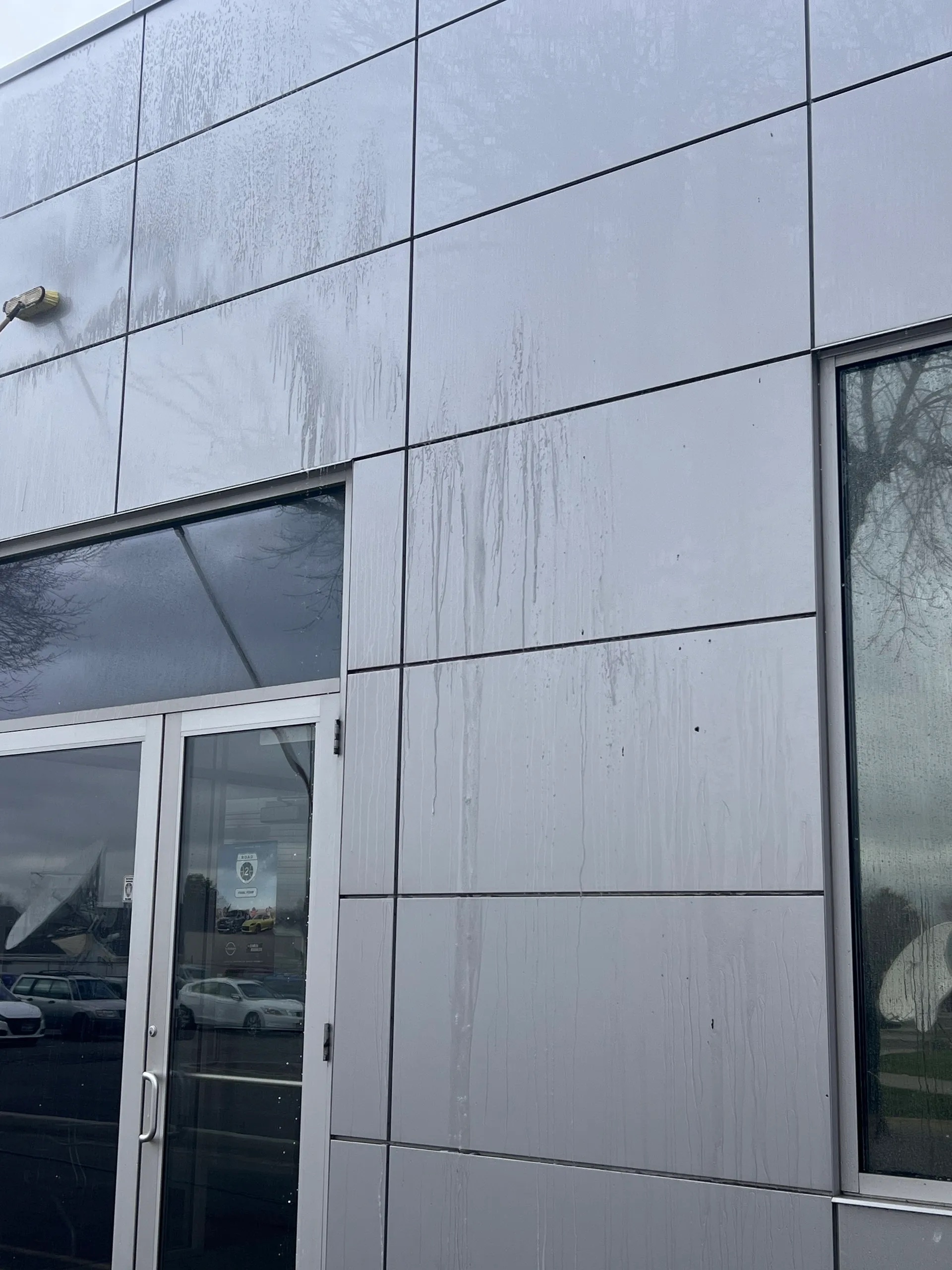 siding of a commercial building being cleaned